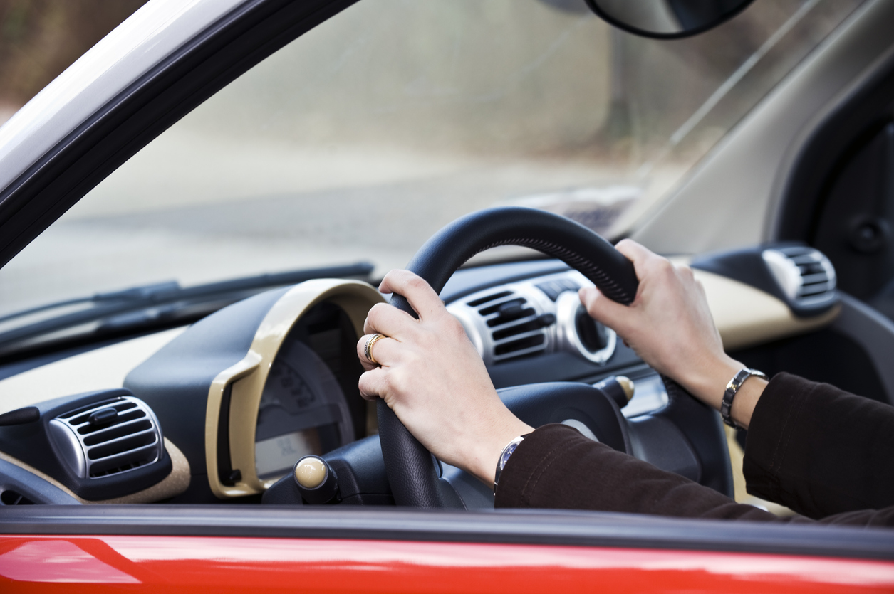 Woman steers car